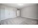 Well-lit bedroom with carpet and double door closet at 5308 Verona Rd # 75, Charlotte, NC 28213