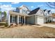 Two-story craftsman style home with gray siding, stone accents, and a two-car garage at 5308 Verona Rd # 75, Charlotte, NC 28213