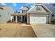 Two-story home with gray siding, stone accents, and a two-car garage at 5308 Verona Rd # 75, Charlotte, NC 28213