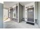 Inviting front porch with gray door and stone accents at 5308 Verona Rd # 75, Charlotte, NC 28213