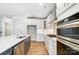Modern kitchen with stainless steel appliances and white cabinetry at 5308 Verona Rd # 75, Charlotte, NC 28213