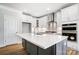 Large kitchen island with white quartz countertops and gray cabinets at 5308 Verona Rd # 75, Charlotte, NC 28213