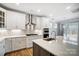 Modern kitchen with island, white cabinets, and stainless steel appliances at 5308 Verona Rd # 75, Charlotte, NC 28213