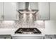 Stainless steel range hood above gas cooktop with white cabinets at 5308 Verona Rd # 75, Charlotte, NC 28213