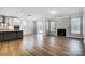 Open concept kitchen and living area with hardwood floors and fireplace at 5308 Verona Rd # 75, Charlotte, NC 28213