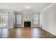Living room with hardwood floors and fireplace, access to backyard at 5308 Verona Rd # 75, Charlotte, NC 28213