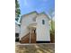 Charming home featuring white siding, black trim and stairs leading up to the front door at 1137 6Th St, Lancaster, SC 29720