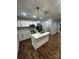 Kitchen features white cabinets, stainless steel appliances, a center island and wood floors at 1137 6Th St, Lancaster, SC 29720