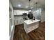 Bright kitchen features white cabinets, stainless appliances, and center island with pendant lighting at 1137 6Th St, Lancaster, SC 29720