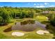 Aerial view of golf course with pond and trees at 108 Fleming Dr, Statesville, NC 28677