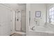 Bathroom with soaking tub, walk-in shower, and tile floors at 108 Fleming Dr, Statesville, NC 28677