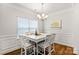 Bright dining room with white table and chairs, hardwood floors, and chandelier at 108 Fleming Dr, Statesville, NC 28677