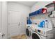 Bright laundry room, washer, dryer, and storage shelves at 108 Fleming Dr, Statesville, NC 28677