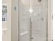 Clean shower stall with a glass door and built-in shelving for storage at 2105 Kennedy Dr, Indian Land, SC 29707
