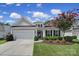 Charming single-Gathering home featuring a well-manicured lawn and attached two-car garage at 2105 Kennedy Dr, Indian Land, SC 29707