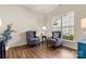 Cozy sitting area featuring hardwood floors, two armchairs, and natural light from the large window at 2105 Kennedy Dr, Indian Land, SC 29707