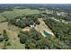 Picturesque aerial view showcasing a pond and lush greenery, complemented by a home surrounded by tall trees at 3814 Watson Church Rd, Monroe, NC 28110