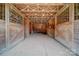 Barn interior featuring multiple horse stalls with wooden construction and open rafters at 3814 Watson Church Rd, Monroe, NC 28110