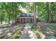 Charming brick home featuring a welcoming front porch, dormer windows, and a meticulously landscaped yard at 3814 Watson Church Rd, Monroe, NC 28110