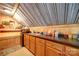 Kitchenette features wood cabinets, sink, and appliances, with wood-paneled walls and metal ceiling at 3814 Watson Church Rd, Monroe, NC 28110