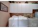 Functional laundry room featuring white cabinets, sink, and washer and dryer at 3814 Watson Church Rd, Monroe, NC 28110