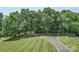 Expansive lawn with a long driveway leading to a secluded home surrounded by lush trees and greenery at 3814 Watson Church Rd, Monroe, NC 28110