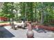 Spacious patio perfect for outdoor dining and entertaining, surrounded by mature trees and a brick retaining wall at 3814 Watson Church Rd, Monroe, NC 28110