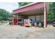 Open shed featuring farm equipment, and space for machinery, including a tractor at 3814 Watson Church Rd, Monroe, NC 28110