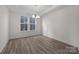 Well-lit dining room with hardwood floors and a stylish chandelier at 633 Amberjack Pl, York, SC 29745