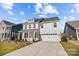 Lovely two-story home with a light-colored exterior, attached two-car garage, and well-manicured lawn at 633 Amberjack Pl, York, SC 29745