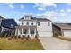 Beautiful two-story home featuring a bright blue front door and a two-car garage at 633 Amberjack Pl, York, SC 29745