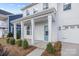 Inviting front porch with stylish columns, a bright blue door, and manicured landscaping at 633 Amberjack Pl, York, SC 29745