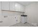 Bright laundry room with upper cabinets and sink at 633 Amberjack Pl, York, SC 29745