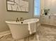 Elegant bathroom featuring a freestanding soaking tub and stylish vanity at 4031 Pritchard Pl, Fort Mill, SC 29715