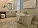 Elegant bathroom featuring a freestanding soaking tub and stylish vanity at 4031 Pritchard Pl, Fort Mill, SC 29715