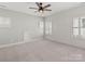 Spacious bedroom with neutral carpet, plantation shutters, and modern ceiling fan at 4031 Pritchard Pl, Fort Mill, SC 29715