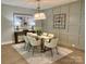 Light-filled dining room features contemporary decor, stylish lighting and a glass table at 4031 Pritchard Pl, Fort Mill, SC 29715