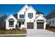 A beautiful two-story home shows a well manicured lawn, a two car garage, and a white brick facade at 4031 Pritchard Pl, Fort Mill, SC 29715