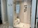 Modern glass shower featuring a built-in bench, niche, and elegant tile design at 4031 Pritchard Pl, Fort Mill, SC 29715