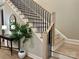 Elegant staircase featuring hardwood steps and modern black iron railings at 4031 Pritchard Pl, Fort Mill, SC 29715