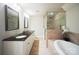 Basement bathroom with double vanity, soaking tub, and walk-in shower at 3012 Wheatfield Dr, Waxhaw, NC 28173