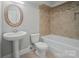 Basement bathroom with pedestal sink, toilet, and bathtub at 3012 Wheatfield Dr, Waxhaw, NC 28173