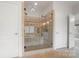 Elegant bathroom featuring a walk-in shower and a built-in bathtub at 3012 Wheatfield Dr, Waxhaw, NC 28173