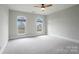 Bright bedroom featuring two arched windows and ceiling fan at 3012 Wheatfield Dr, Waxhaw, NC 28173
