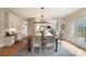 Bright dining room features a large table, chandelier, and access to deck at 3012 Wheatfield Dr, Waxhaw, NC 28173