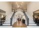 Two-story foyer with a grand staircase and hardwood floors at 3012 Wheatfield Dr, Waxhaw, NC 28173