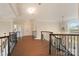 Upstairs hallway with hardwood floors and elegant railing at 3012 Wheatfield Dr, Waxhaw, NC 28173