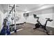 Basement gym with exercise equipment, including a Peloton bike and weight rack at 3012 Wheatfield Dr, Waxhaw, NC 28173