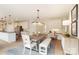 Open concept kitchen with island, breakfast nook, and white cabinets at 3012 Wheatfield Dr, Waxhaw, NC 28173
