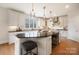 Modern kitchen with white cabinets, granite counters and island at 3012 Wheatfield Dr, Waxhaw, NC 28173